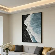 Large beach wave wall art in a cozy coastal lounge area with rattan furniture