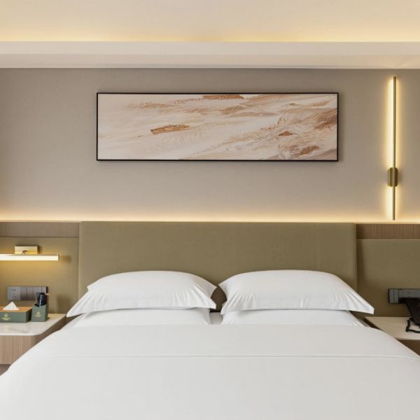 zhuhai meichen hotel guest room interior with minimalist abstract wall painting above bed
