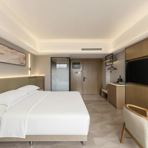 zhuhai meichen hotel guest room interior with minimalist abstract wall painting above bed