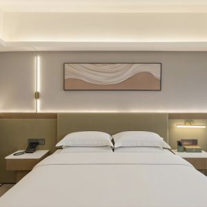 zhuhai meichen hotel guest room interior with minimalist abstract wall painting above bed